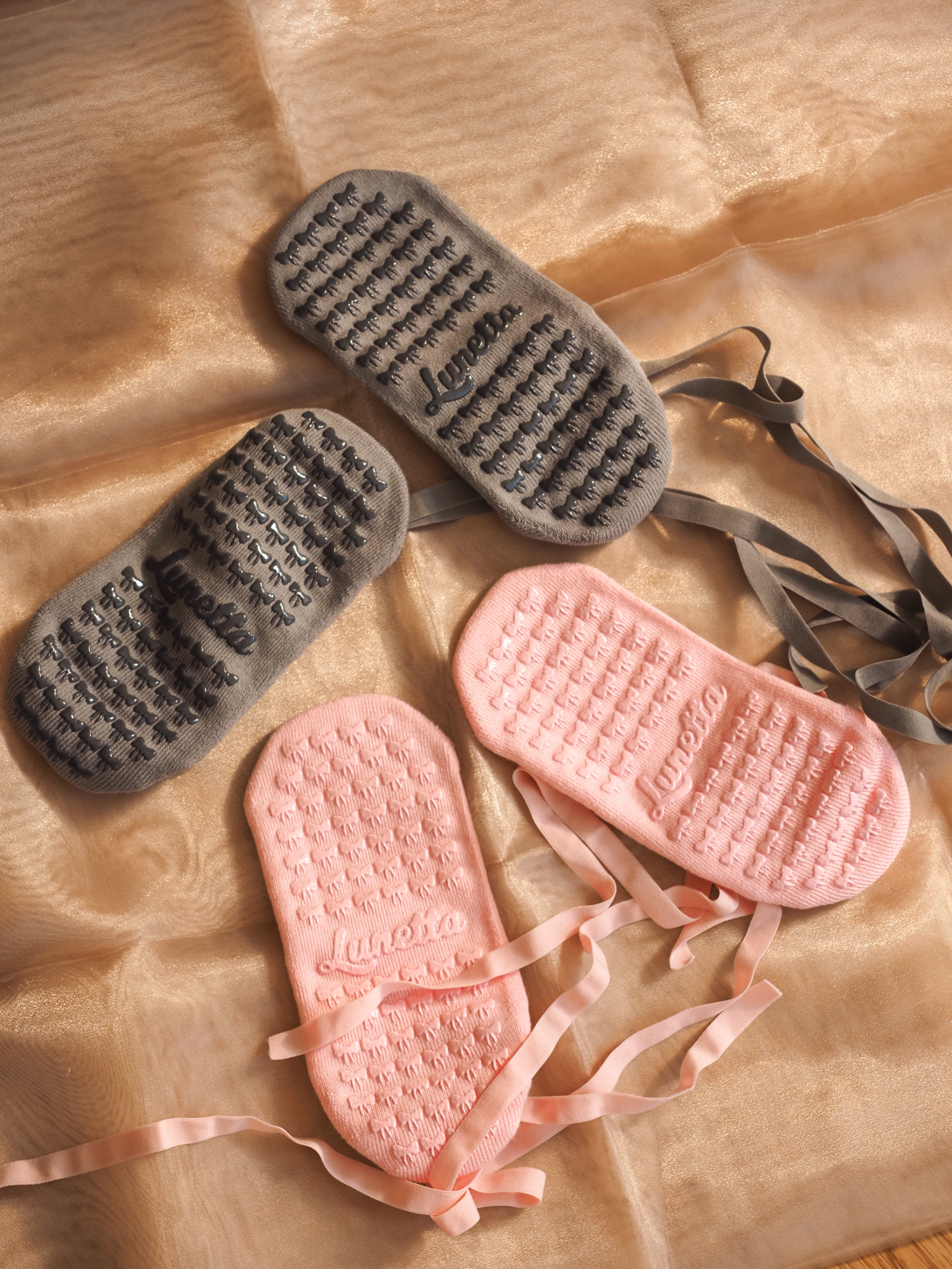 Back of the ballet-style grip socks in blush and charcoal colors.