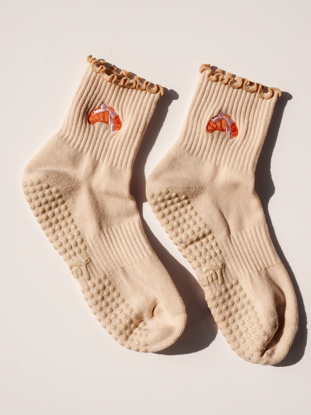 Product shot of Croissant Lover grip socks