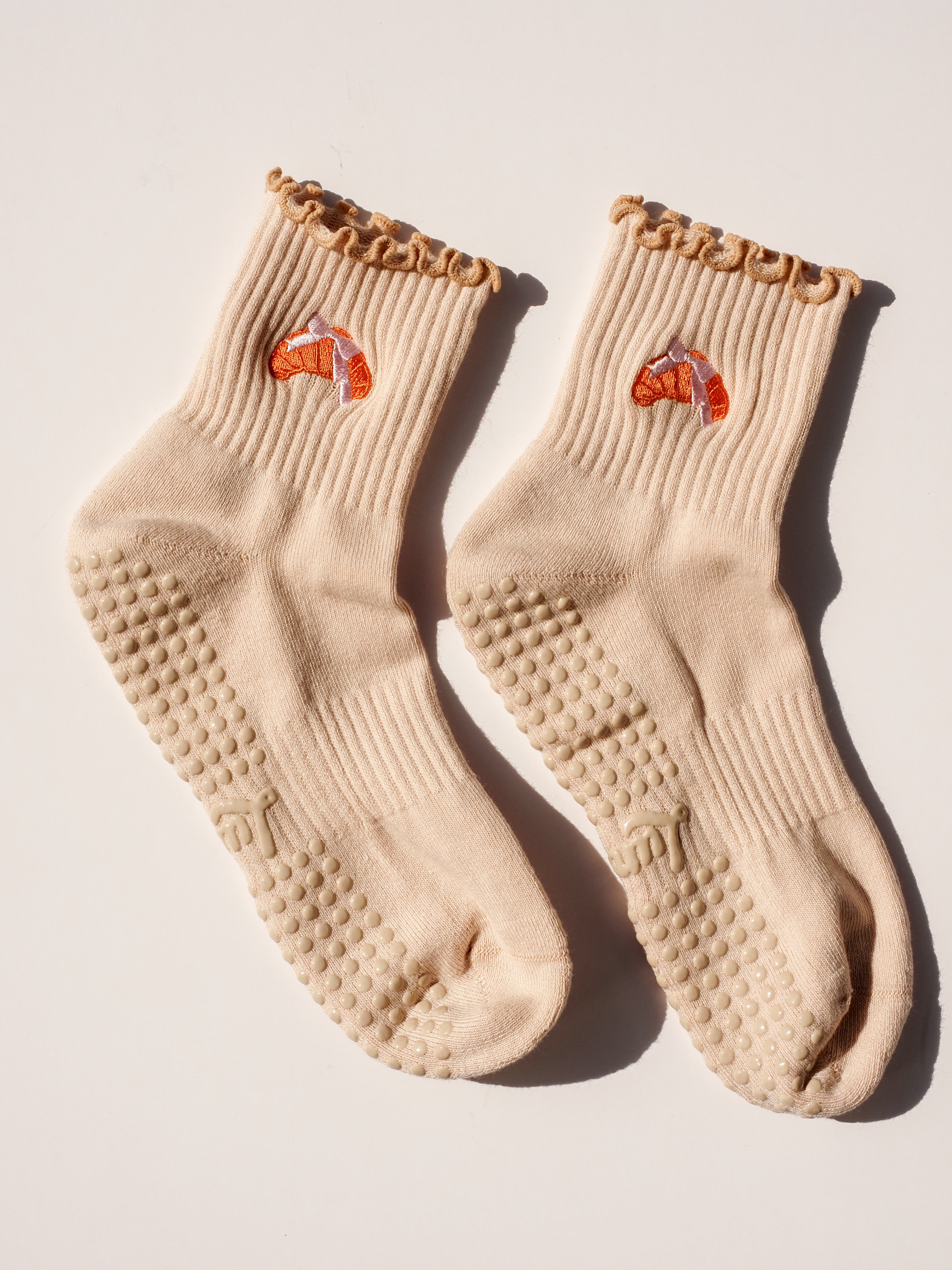 Product shot of Croissant Lover grip socks