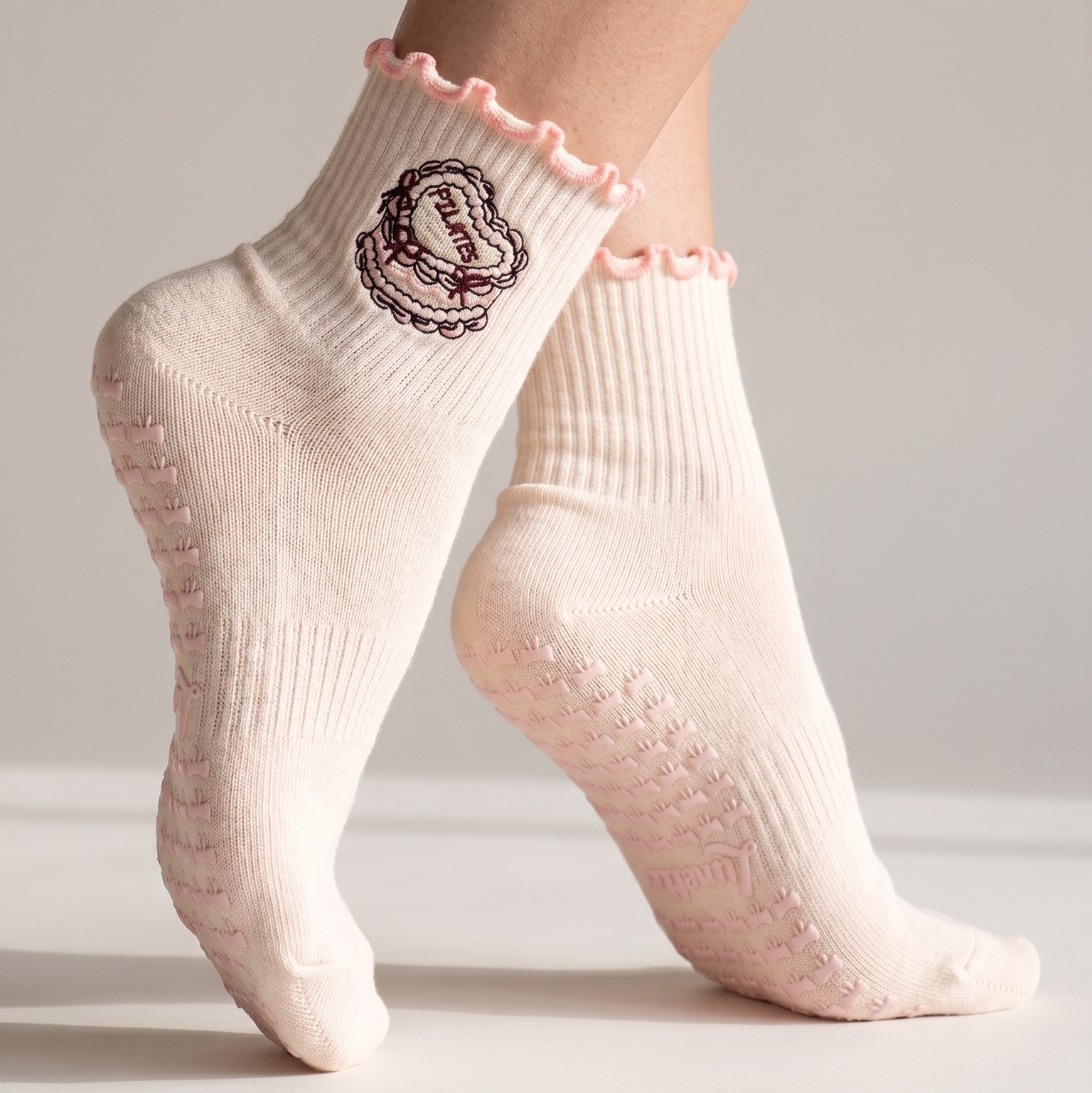 Pink pilates socks with cake pattern on feet